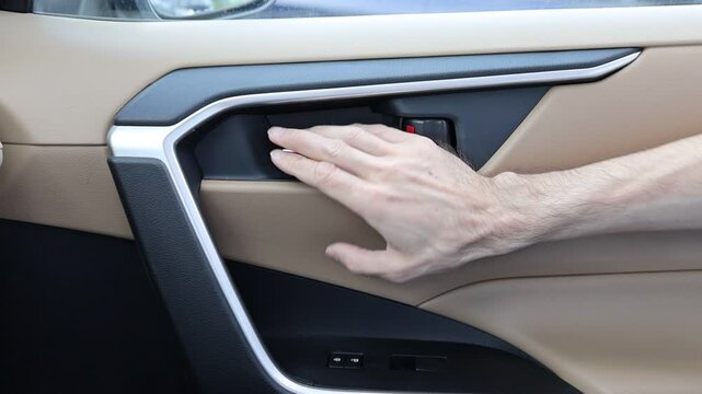 Men hand pull silver handle of car door and push on door