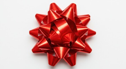 A shiny red gift bow with many loops centered on a plain white background casting a soft shadow