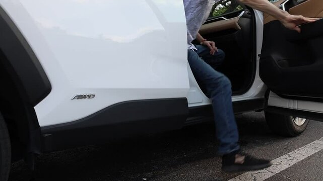 Men open car door and out of car leving vehicle