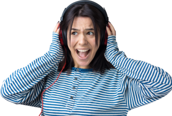 A young girl in a striped vest is listening to music in red headphones in a studio and dancing.