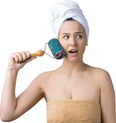 Brunette with a towel on her head using roller for face massage isolated on grey background