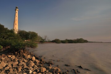 This historic Dutch colonial lighthouse is located on Sembilangan Beach, in Sambilangan Village, Bangkalan Regency, on Madura Island, East Java, Indonesia. The lighthouse stands as a maritime heritage