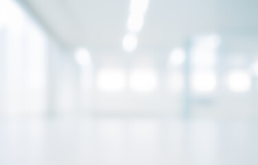 Blurred interior space with white walls and bright lighting creating a soft background.