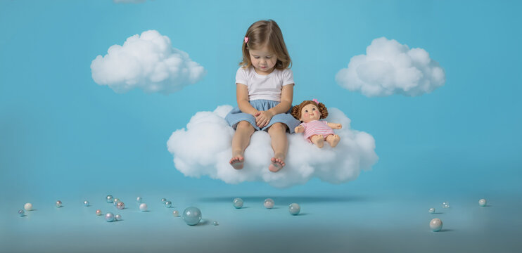 Sadness. Little girl in the clouds.