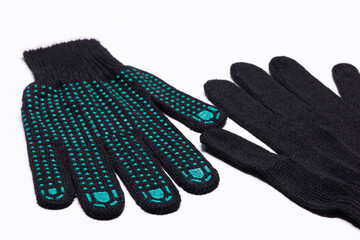 Pair of black work gloves with green rubber grip dots, front and back view on white background