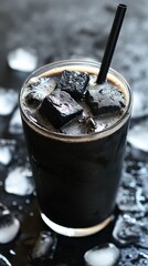 Close-up of a dark drink with black ice cubes.