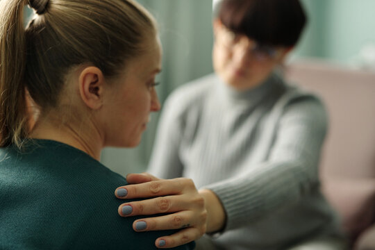 Psychologist Putting Hand on Patients Shoulder