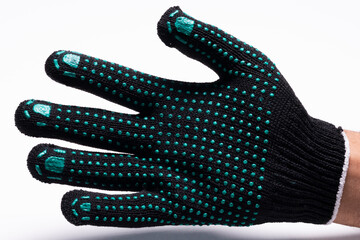 Black safety work glove with green rubber grip dots on white background