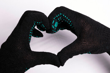 Hands in gloves forming heart shape on white background - futuristic gesture with digital glove pattern