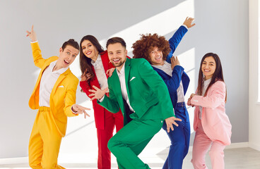 Dancing, acting group people in vibrant vivid formal suit, cool happy dance, office party gathering. Young cute disco team color suit set wear, express enjoyment, colorful mood, event or performance