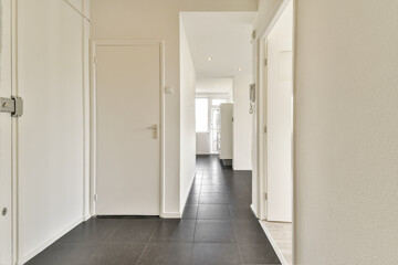 Obraz premium A sleek and modern interior hallway featuring clean lines, white walls, and a minimalist style. Ideal for contemporary home decor inspiration.