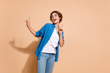 Photo of young dancing manager lady wearing blue shirt chilling pointing fingers up feel positive...