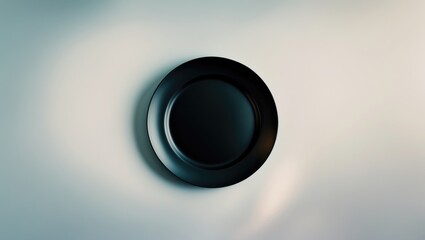 Empty black stoneware dish set against a white background.