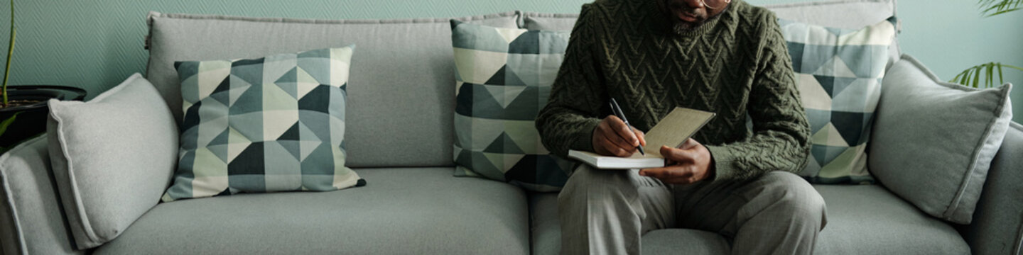 Male Psychologist Writing in Notebook Header