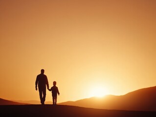 Father and son walking at sunset