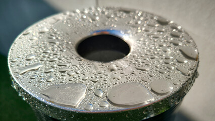 water drops om metal surface close up