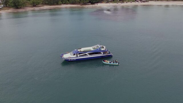 Drone glides in closer toward the Ferry El Condor off Mahambo&rsquo;s reef coastline as it prepares for its voyage to &Icirc;le Sainte-Marie, capturing intimate departure moments.