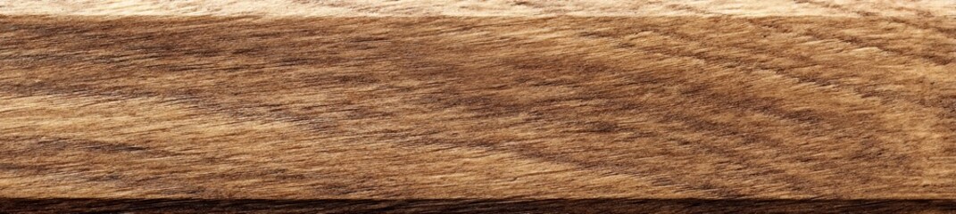 Fototapeta premium The background consists of a super long walnut plank that acts as a texture element, emphasizing the walnut wood texture
