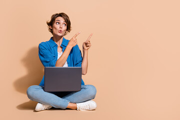 Full body size photo of business development specialist woman pointing finger with laptop project plan isolated on beige color background