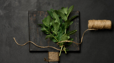 Bunch of fresh green mint on wooden board, top view