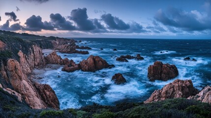 Obraz premium A beautiful coastline scene shows rocks beside the expansive ocean waters