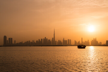 sunset over the city of dubai with a boat