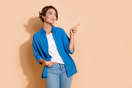 Photo of young business woman wear blue shirt pointing finger empty space cryptocurrency startup isolated on beige color background
