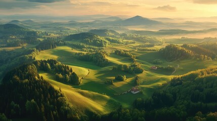 Forested mountain summits fading into sprawling green farmland, captured from above