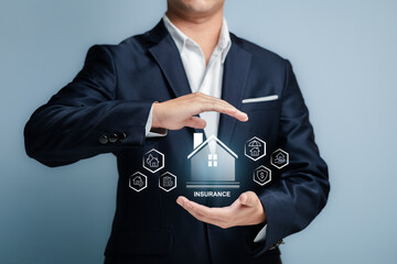 Man in Suit Holding Insurance Icons with House Symbol on Screen