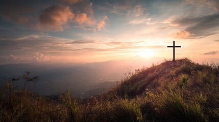 Christian cross standing on a hill during sunrise. Ascension of Jesus concept. Beautiful nature during sunrise or sunset. Cross on top of a hill, Christianity theme.