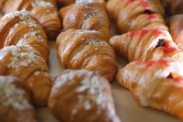 A variety of fresh pastries in the bakery window. Sweet big Croissant on shelf show for sale