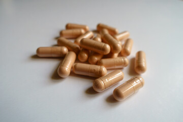Closeup of heap of pink capsules of palmitoylethanolamide dietary supplement