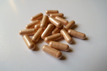 Heap of pink capsules of palmitoylethanolamide dietary supplement