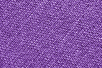 Texture of purple natural fabric with large diagonal weaving. Surface, structure of upholstery or carpet material, cloth background close up.