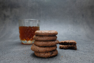 Stack of Chocolate Cookies with Coffee and Rustic Background
