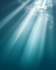 Obraz premium Soft rays of light break through wispy clouds against a calming blue sky during a tranquil afternoon