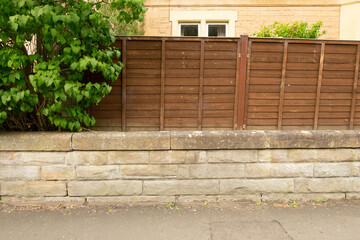 Stone wall and wooden fence, in the Victorian suburban of Morningside, Edinburgh, Scotland, UK