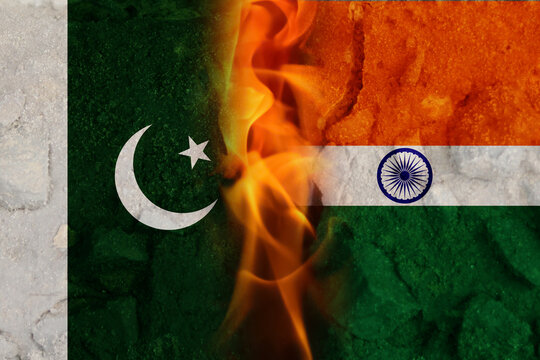 Abstract representation of India and Pakistan flags with flames and fire symbolizing conflict and tension along the border, with a military backdrop evoking a sense of war and unrest