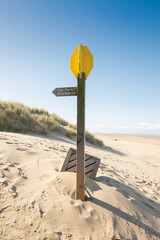 Wooden signpost to car park on the deserted sandy beach at Formby, Merseyside, England,UK