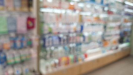 Blurred view of colorful pharmacy shelf display .