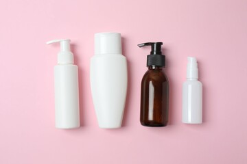 Natural cosmetic products on a pink background, top view