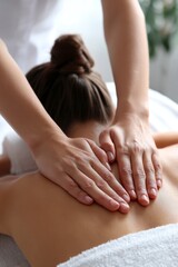 A man is receiving a back massage with oil from a physiotherapist