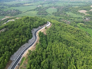 Aerial view of the road that cuts through the hill at Clongop Hill, Gunungkidul Yogyakarta