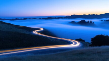 A long curving road weaves through fog at twilight time
