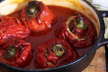 Stuffed bell peppers with meat and rice in tomato sauce, and spicy seasoning. homemade vegetarian dinner - baked colorful paprika stuffed with rice
