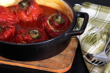 Stuffed bell peppers with meat and rice in tomato sauce, and spicy seasoning. homemade vegetarian dinner - baked colorful paprika stuffed with rice