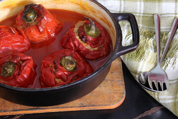 Stuffed bell peppers with meat and rice in tomato sauce, and spicy seasoning. homemade vegetarian dinner - baked colorful paprika stuffed with rice