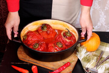 Stuffed bell peppers with meat and rice in tomato sauce, and spicy seasoning. homemade vegetarian dinner - baked colorful paprika stuffed with rice