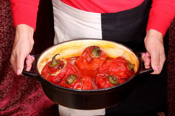 Stuffed bell peppers with meat and rice in tomato sauce, and spicy seasoning. homemade vegetarian dinner - baked colorful paprika stuffed with rice