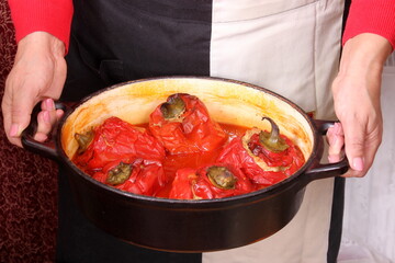 Stuffed bell peppers with meat and rice in tomato sauce, and spicy seasoning. homemade vegetarian dinner - baked colorful paprika stuffed with rice